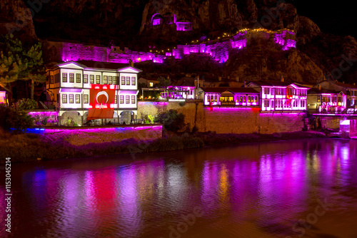 Turkish flag on Old Ottoman houses night and mirrored view by the Yesilirmak River in Amasya. Amasya is the capital of the Black Sea Region. photo