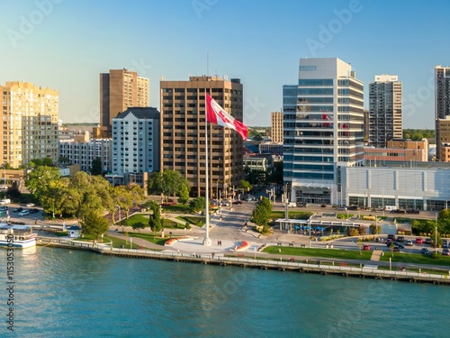 Aerial view of downtown city park, with the Canadian flag, and people relaxing. Cityscape with modern buildings and a riverfront park. , WINDSOR, ONTARIO, CANADA