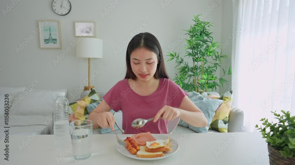 Asian young woman eating vietnamese spring rolls in living room at home. Asian young woman eating vietnamese spring rolls in living room at home.