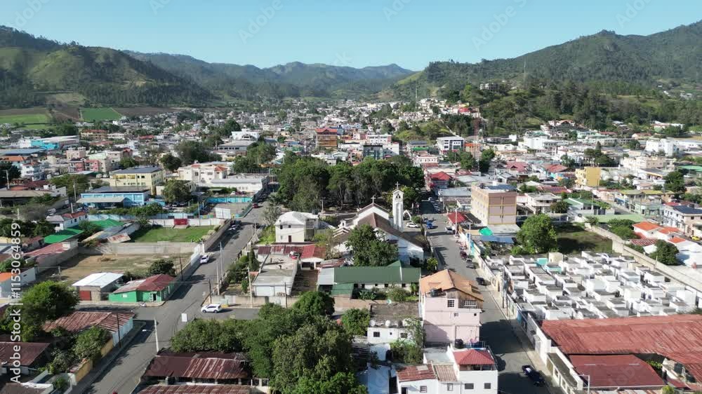 Aerial view of the town center and the central park of Constanza in the Central Range of the Dominican Republic on a sunny summer day Aerial view of the town center and the central park of Constanza in the Central Range of the Dominican Republic on a sunny summer day