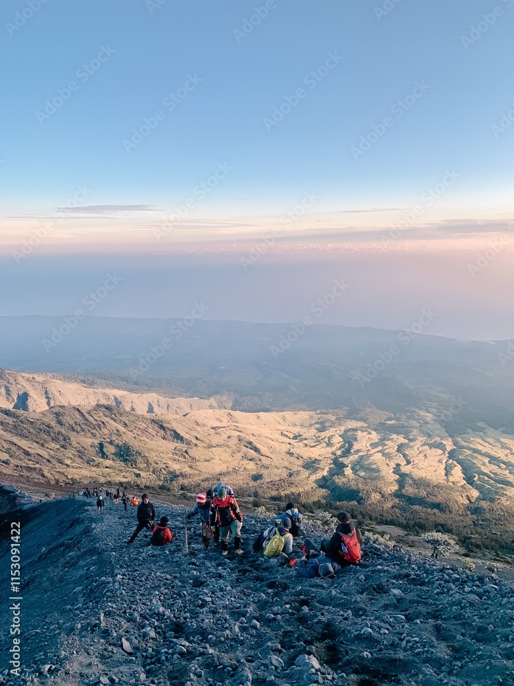 Fototapeta premium Hikers Ascending Mount Rinjani at Sunrise, Indonesia