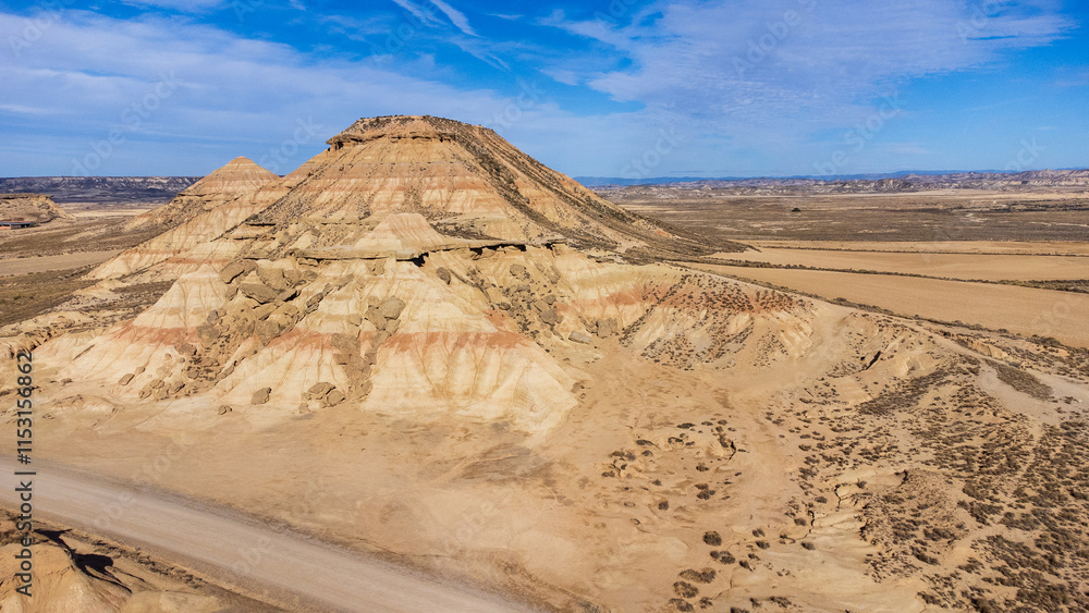 Fototapeta premium Yellow-red hills, semi-desert badlands. Aerial. Bardenas Reales, Navarra, Spain.
