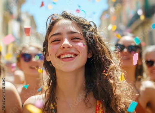 Portrait of a cheerful young woman enjoying a festive event, while colorful confetti falls around her. The concept of the holiday.