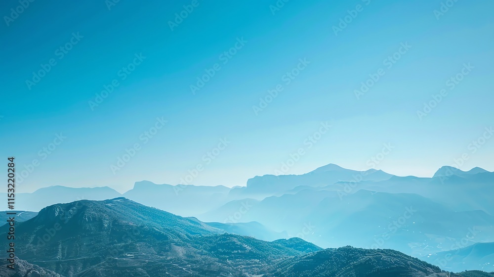 A panoramic view of a mountain range with a clear blue sky. A panoramic view of a mountain range with a clear blue sky.