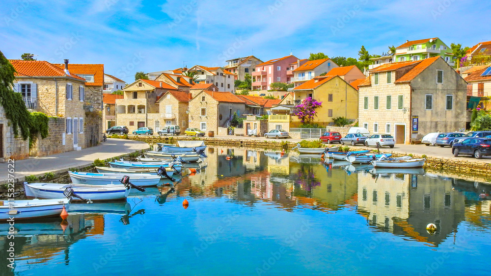 Obraz premium View of the monuments of Vrboska, attractions on the island of Hvar, moored boats in the bay