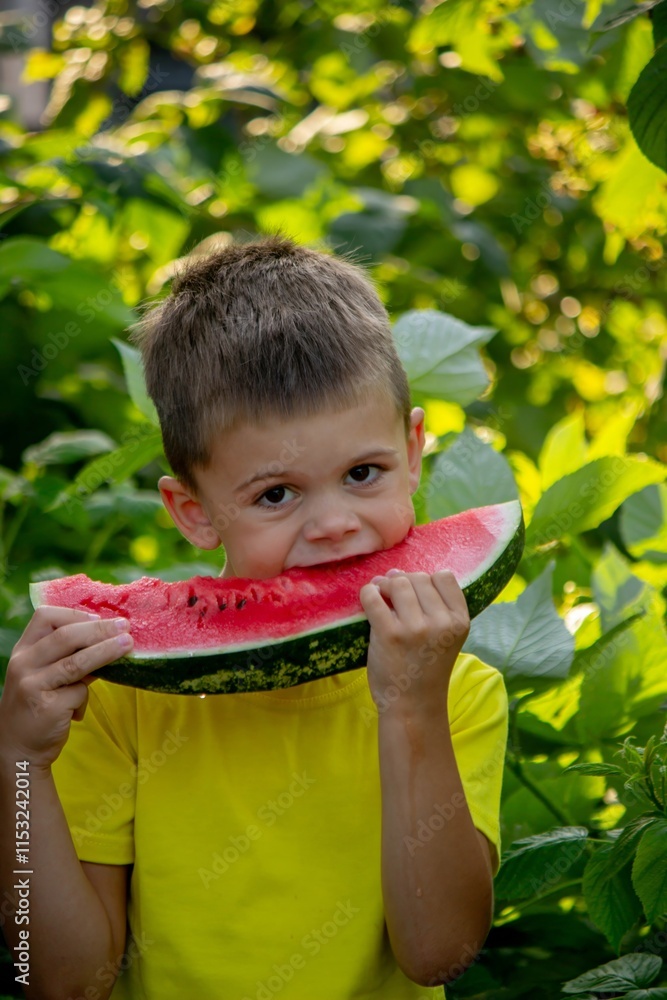 The child eats watermelon in the summer. Selective focus The child eats watermelon in the summer. Selective focus