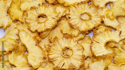 Crisps, handmade dried pineapple snacks, fruit background, selective focus