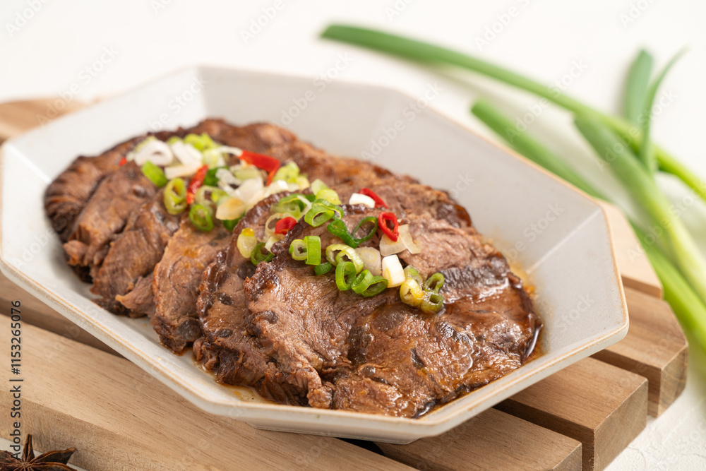 Taiwanese braised beef shank slices in a plate on white table background.