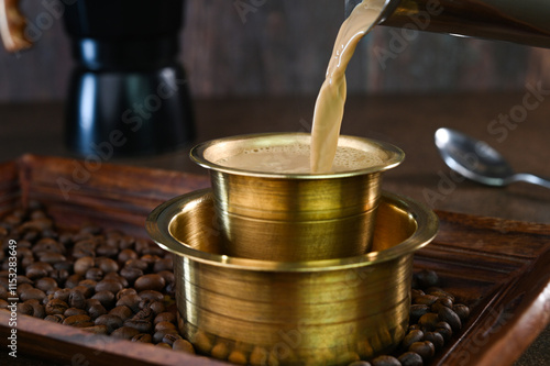 Serving Indian filter coffee in a cup.