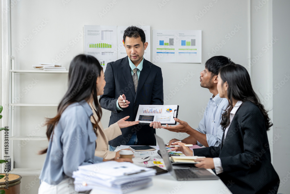 The man is holding a tablet and is talking to the group The man is holding a tablet and is talking to the group