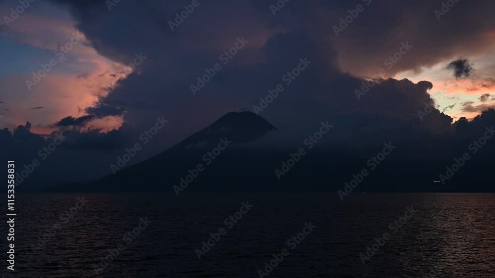 Electric storm and lightning strike the Atitlan volcano on the edge of Lake Atitlan in Guatemala during sunset Electric storm and lightning strike the Atitlan volcano on the edge of Lake Atitlan in Guatemala during sunset