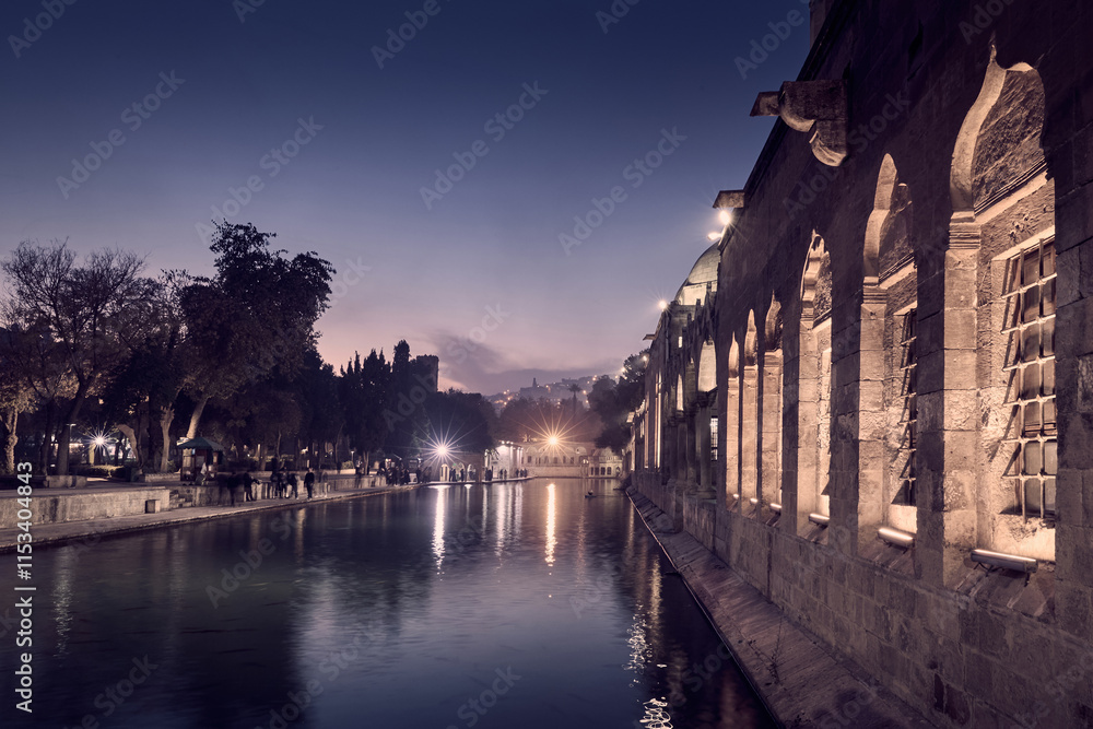 Fototapeta premium Rizvaniye mosque at Fish lake in Sanliurfa city at night, Turkey
