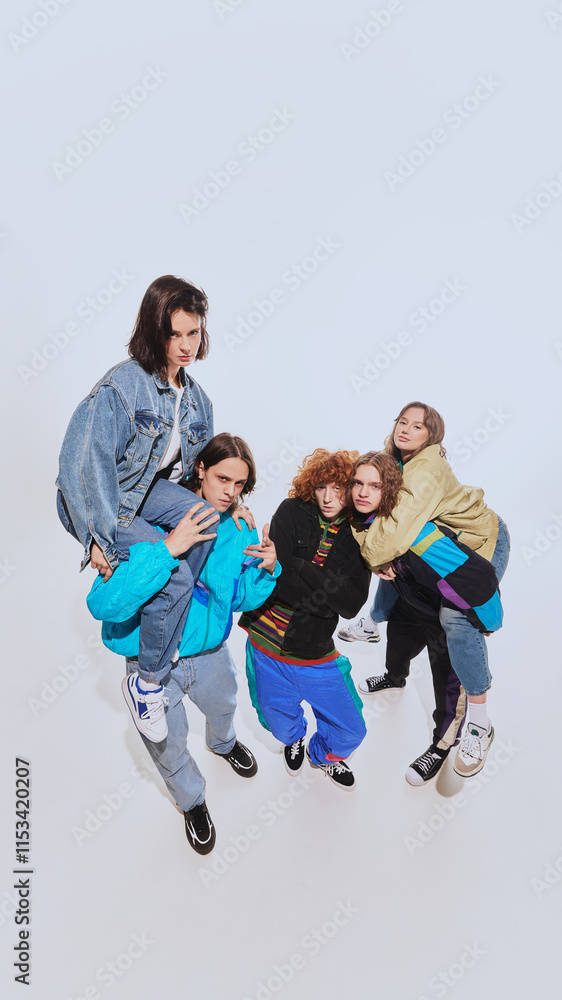 90s party. Group of stylish young friends in their 20s, wearing stylish retro0inspired outfits and posing against white studio background. Concept of 90s fashion, retro style, youth 90s party. Group of stylish young friends in their 20s, wearing stylish retro0inspired outfits and posing against white studio background. Concept of 90s fashion, retro style, youth