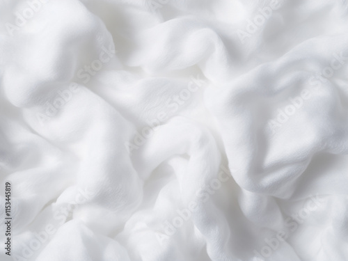 Background texture of white cotton wadding highlights its soft and fluffy nature