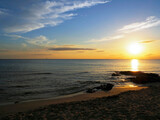 Beautiful afterglow of sunset at the horizon. Yellowish summer sundown from the beach of Gallipoli, Puglia, Italy.