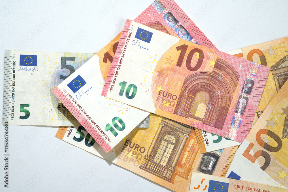 Top view of a pile of euro banknote cash on a white background Top view of a pile of euro banknote cash on a white background