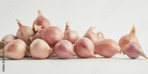 Shallots showcased in a still life composition against a white background, highlighting the onion bulb as a versatile herb and vegetable ingredient for various culinary creations. photo