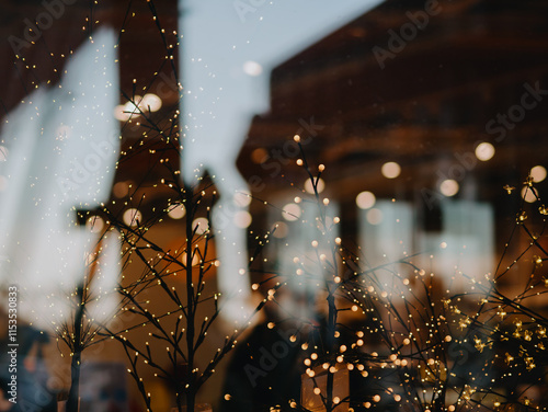 A garland of light bulbs glows behind a glass shop window before Christmas and New Year. Scandinavian supermarket chain with home and interior goods. Pula, Croatia - November 13, 2024 photo