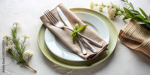 Modern Minimalist Table Setting: White Plate, Silverware, Textured Napkin on White Background