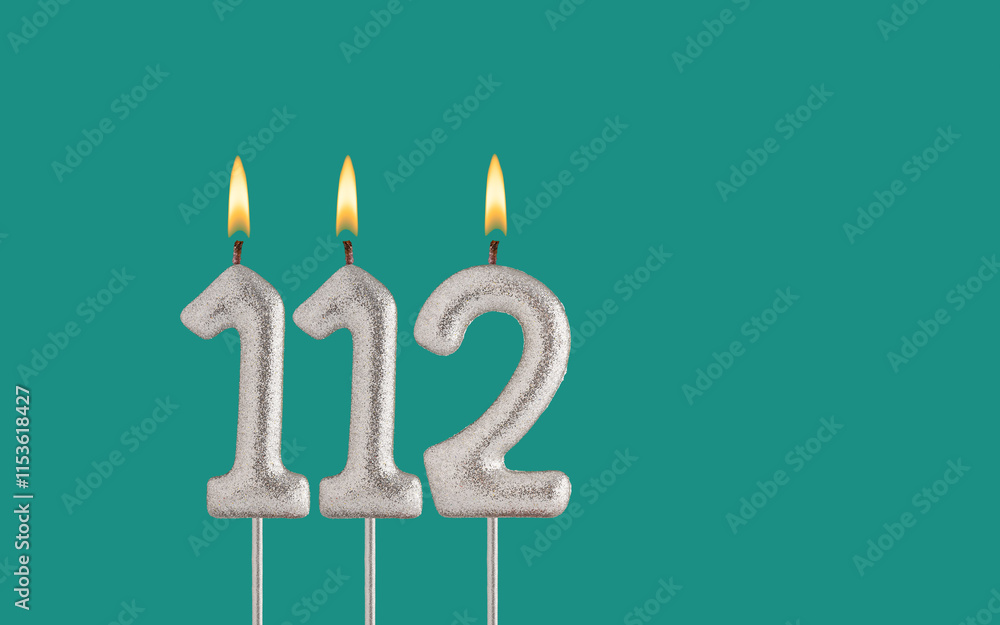 Birthday candle number 112 - Card on a green background. Birthday candle number 112 - Card on a green background.