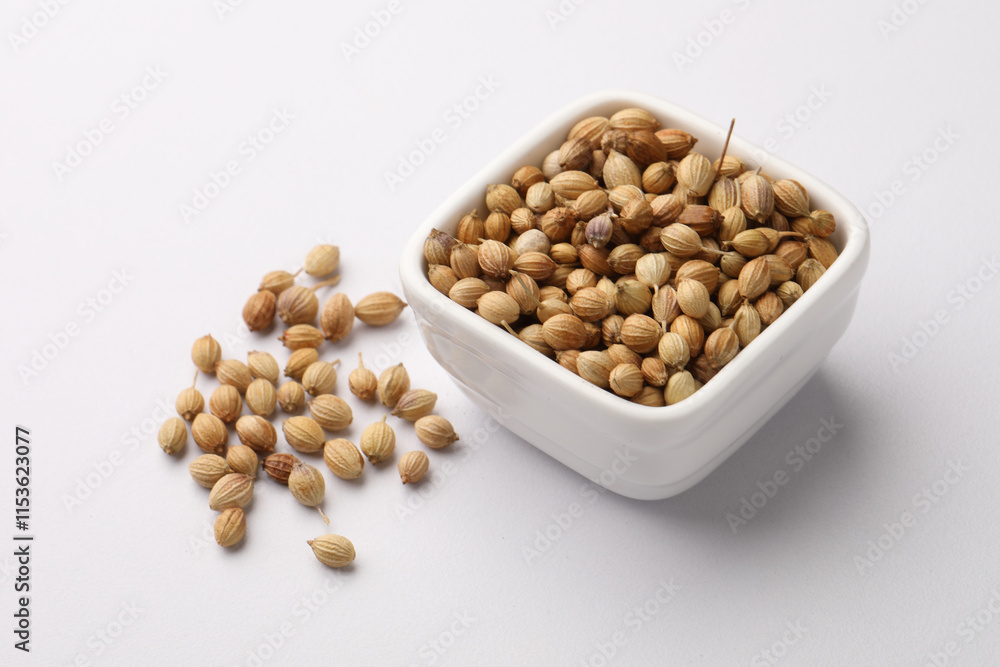 Indian spice Coriander seeds in a small ceramic bowl Indian spice Coriander seeds in a small ceramic bowl