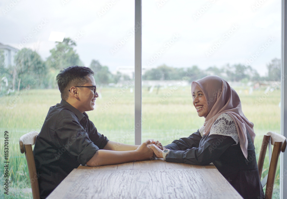 Portrait of romantic muslim couple making heart gesture with their hands, loving arab man and woman in hijab celebrating Valentine's Day, looking at camera and smiling, posing over beige background Portrait of romantic muslim couple making heart gesture with their hands, loving arab man and woman in hijab celebrating Valentine's Day, looking at camera and smiling, posing over beige background