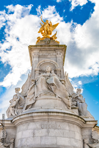 Low-angle shot of the famous Victoria Memorial, a monument to Queen Victoria, located at the end of The Mall in London by sculptor Sir Thomas Brock. At the top stands a gilded bronze Winged Victory.