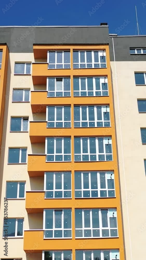 Facade of a new apartment building. Modern multi storey house with bright walls. Block of flats with large balconies. Front view. Vertical video Facade of a new apartment building. Modern multi storey house with bright walls. Block of flats with large balconies. Front view. Vertical video