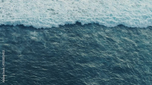 Endless ocean waves top view waves moving endless and ever-changing nature of sea. Tidal pulse high-angle view of ocean waves revealing pulsating energy flow and crash raw power motion of ocean.