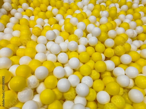 colorful balls, white and yellow plastic balls. horizontal background.