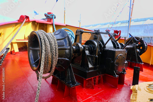 Tugboat winch and mooring ropes situated at the prow end of the ship
