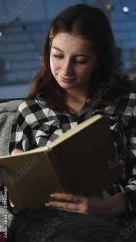 Young Attractive Girl In An Evening Room Reading Notes In A Notebook And Planning The Next Day, Vertical Video