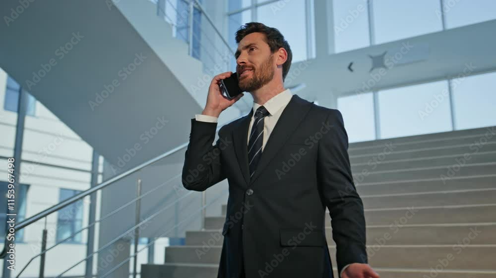 Businessman enjoying friendly call on office stairs closeup. Confident manager Businessman enjoying friendly call on office stairs closeup. Confident manager