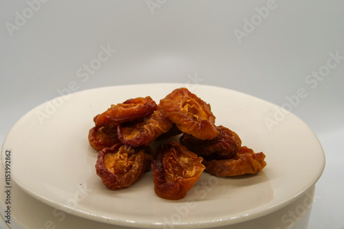 Wallpaper Mural Dried nectarine fruit on a white plate in front of a white background Torontodigital.ca