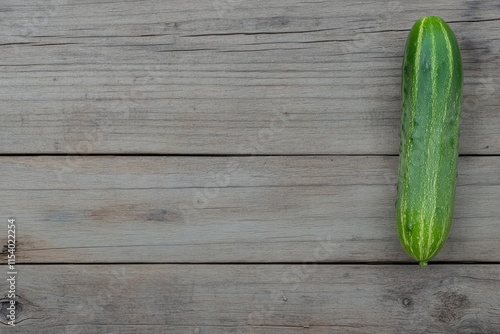 Fresh Green Cucumber on Rustic Wooden Background. A Healthy and Delicious Vegetable. Perfect for Summer Dishes. photo