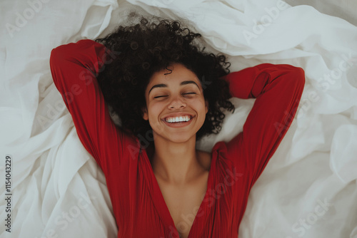 Happy Woman in Red Dress Relaxing on White Sheets, Smiling