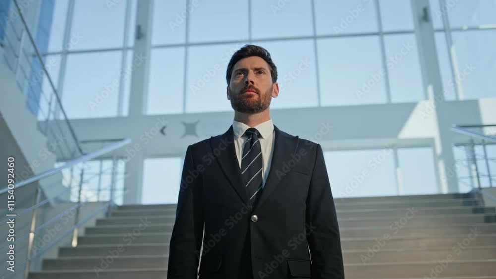 Elegant businessman standing staircase modern building closeup. Confident man Elegant businessman standing staircase modern building closeup. Confident man