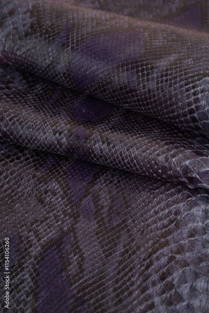 Obraz premium Snake skin fabric texture with waves and folds. Background with a reptile skin texture. Genuine python snakeskin