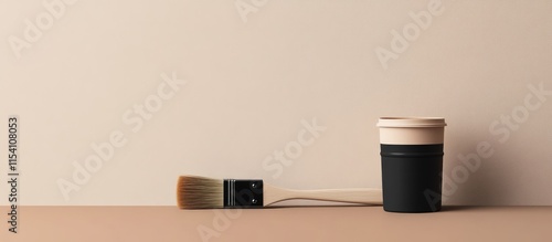 Paint brush and can on neutral beige backdrop perfect for home repair and DIY projects with minimalist aesthetic and clean design photo