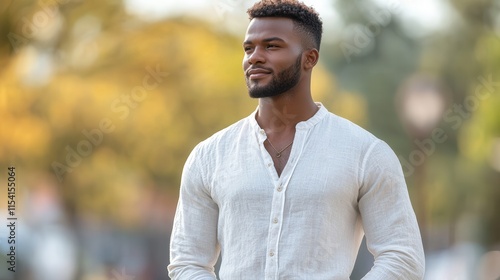 Elegant african man in ethically crafted linen shirt, featuring natural outdoor setting. photo