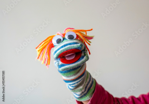 Colorful sock puppet performing in a playful indoor setting for children’s entertainment photo