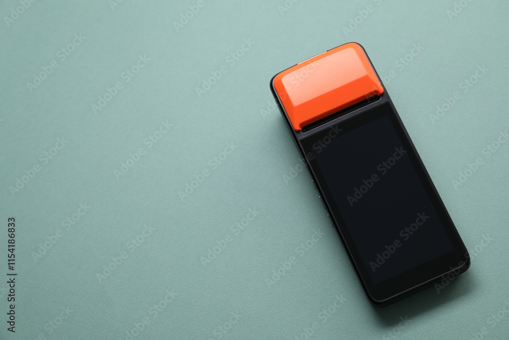 One payment terminal on pale turquoise background, top view. Space for text One payment terminal on pale turquoise background, top view. Space for text