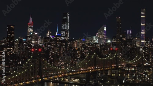Wallpaper Mural Illuminated New York City skyline enchants at night, showcasing iconic Manhattan skyscrapers and Queensboro Bridge over East River Torontodigital.ca
