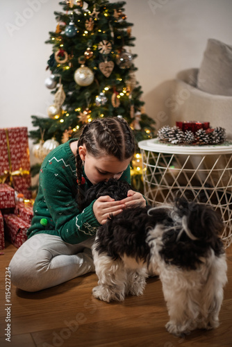 Christmas Joy: Girl Playing with Her Dog by the Christmas Tree