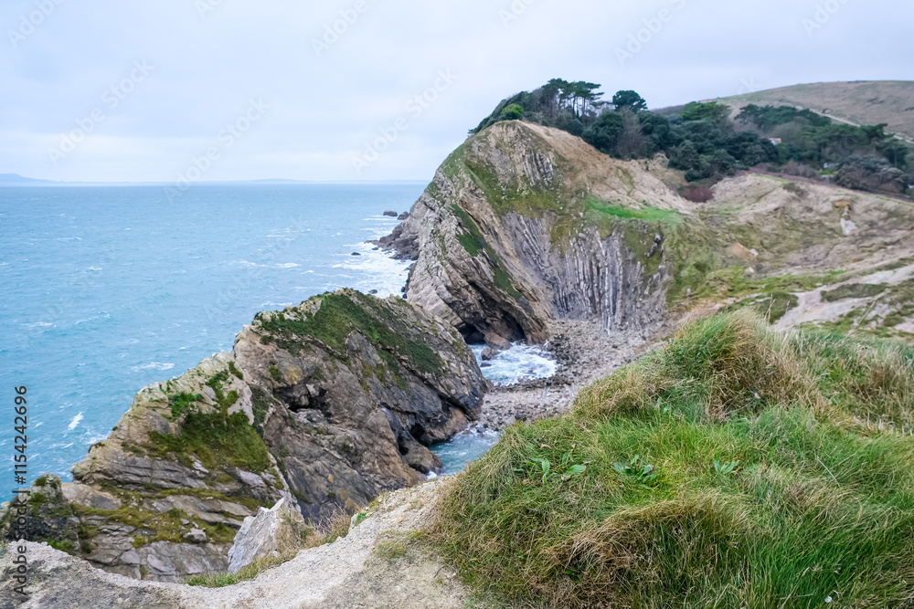 Jurassic coast view in Dorset. Cold winter day. Lulworth Cove cliffs view on a way to Durdle Door. The Jurassic Coast is a World Heritage Site on the English Channel coast. Stair Hole view Jurassic coast view in Dorset. Cold winter day. Lulworth Cove cliffs view on a way to Durdle Door. The Jurassic Coast is a World Heritage Site on the English Channel coast. Stair Hole view