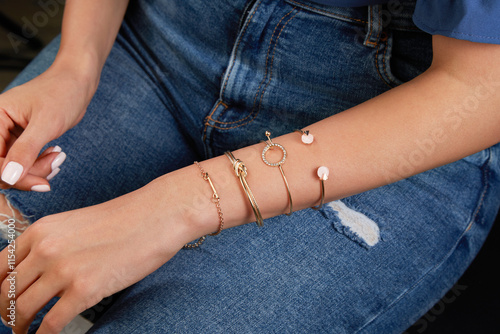 Gold combination bracelets on a photomodel's arm