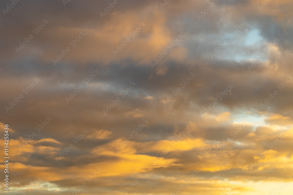 The evening sky with a few clouds at sunset, as a background The evening sky with a few clouds at sunset, as a background