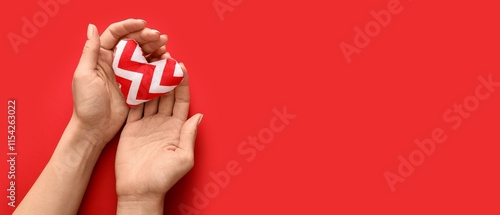 Hands holding fabric heart ...