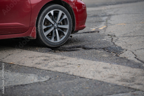 Car driving over a pothole in Marysville, CA photo