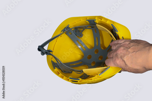 Obraz na płótnie Worker holding a yellow hard hat for safety at work w salonie